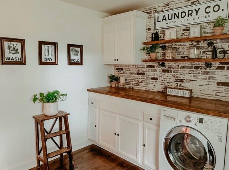 Rustic Red Brick Laundry Room Wall and White Shaker Cabinets