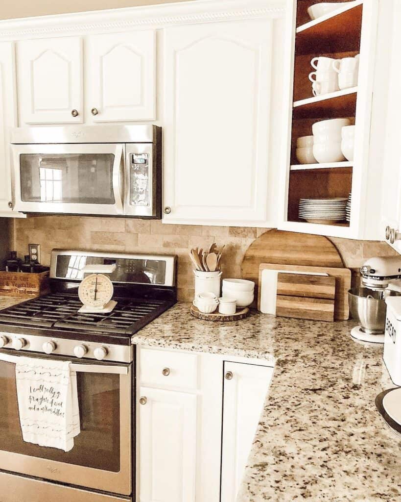 Sand Beige Tile Backsplash with Granite Countertops Alongside White Cabinets