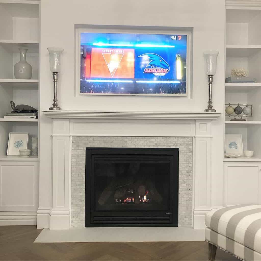 Silver Fireplace Sconces and a Wood Herringbone Floor