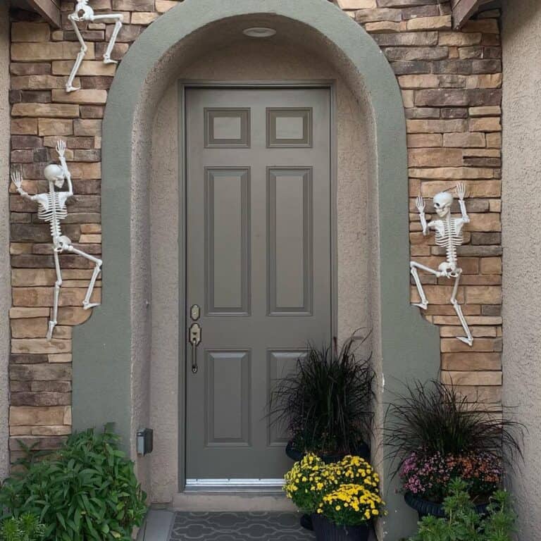 Skeletons Climbing a Stone Wall