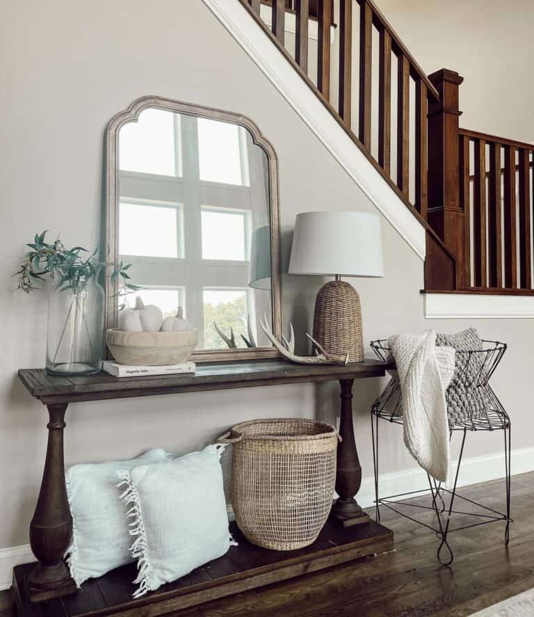Stained Wood Staircase Railing Over Console Table