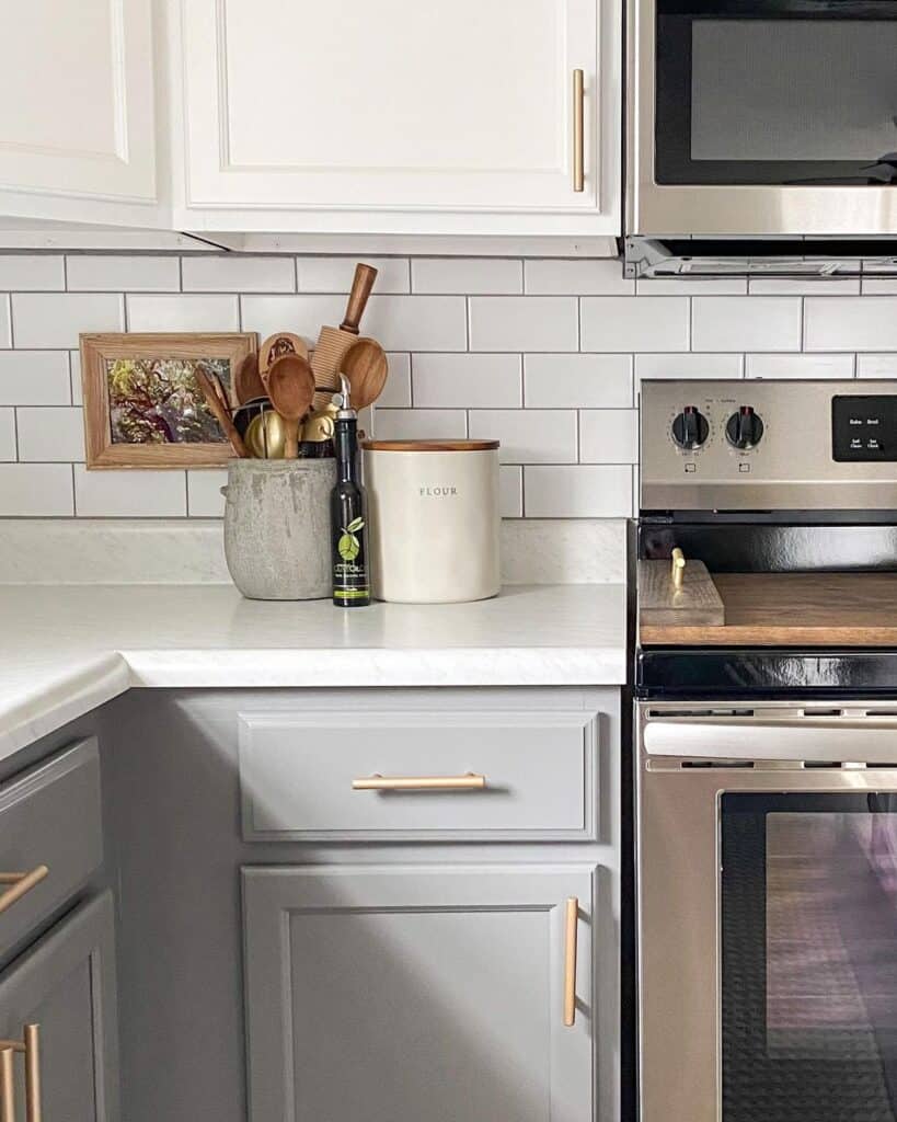 Stainless Steel Stove Pushed Against White Subway Tile Backsplash