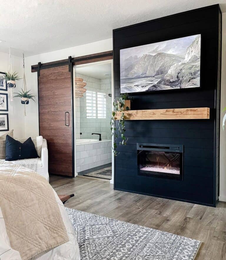 TV Mounted Above Black Fireplace
