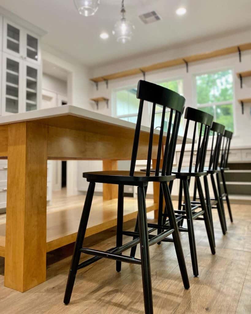 Tall Black Wood Dining Chairs at a Wooden Table with a White Top