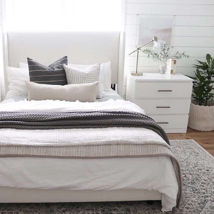 Taupe Patterned Rug Beneath White Bedframe