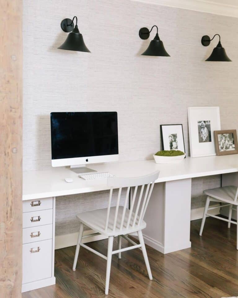 Three Sconces Above Modern White Desk