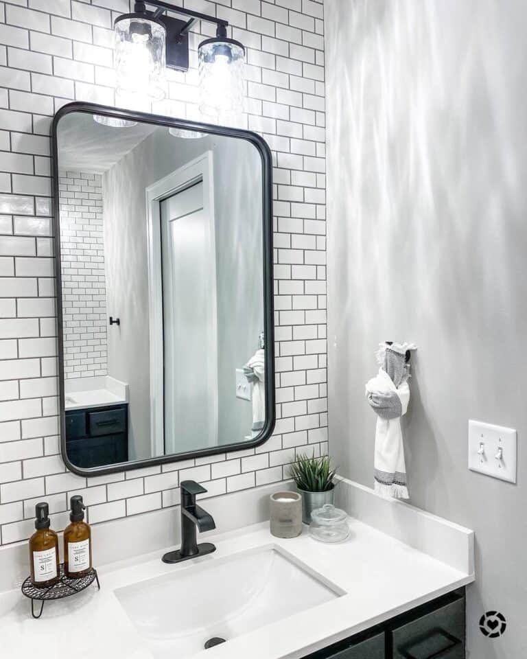 Tile Bathroom Wall with Black Framed Mirror