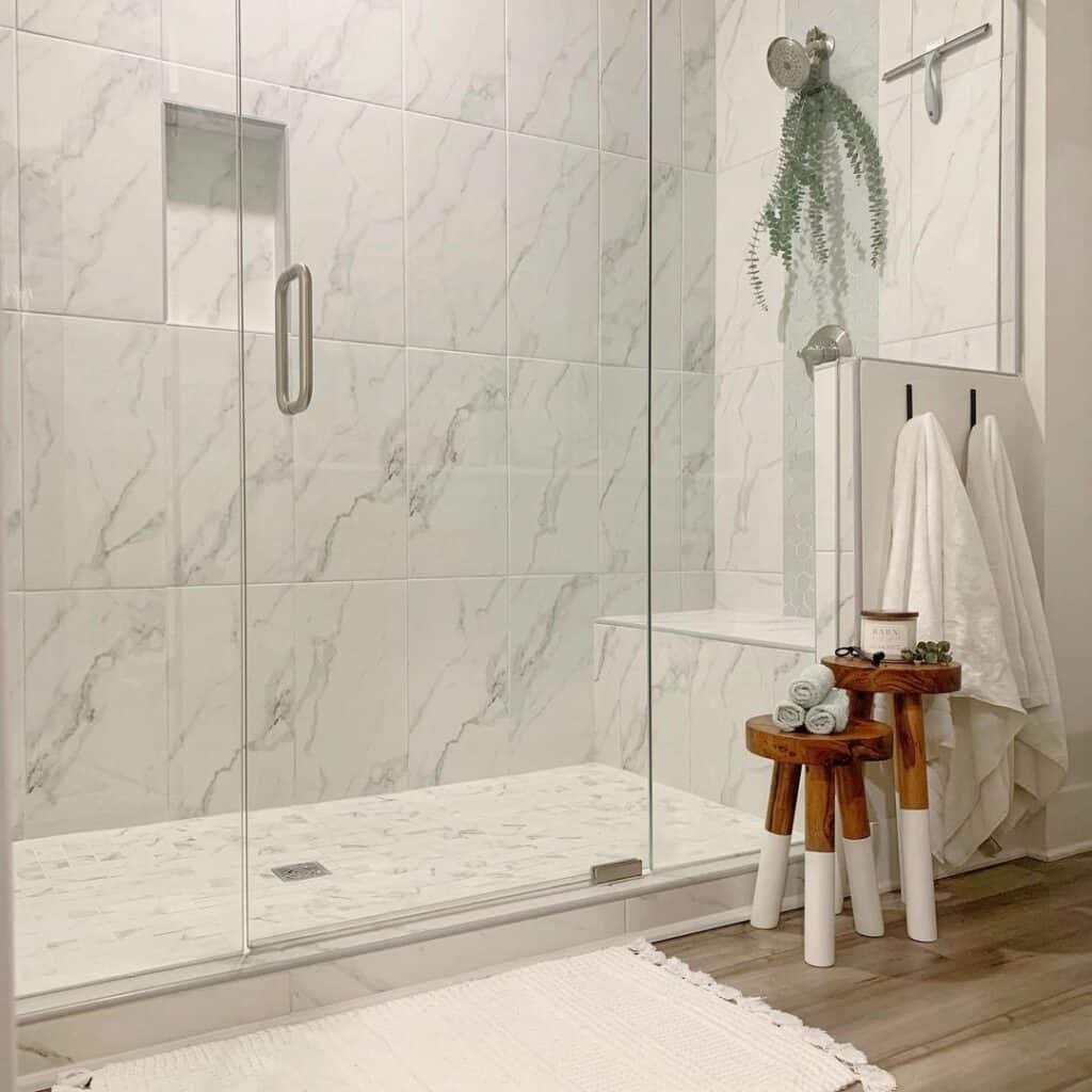 Two Stools Outside Large White Tiles on Shower Walls