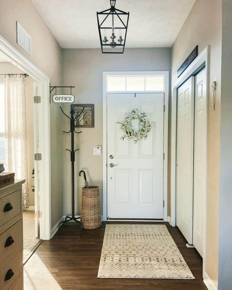 Umbrella Stand Next to a 6 Panel White Front Door