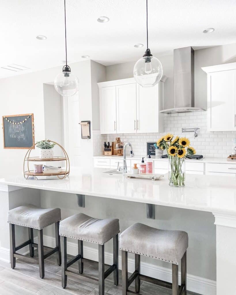 Upholstered Stools Under White Kitchen Island