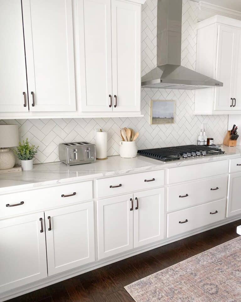 White Cabinets with Herringbone Tile Backsplash