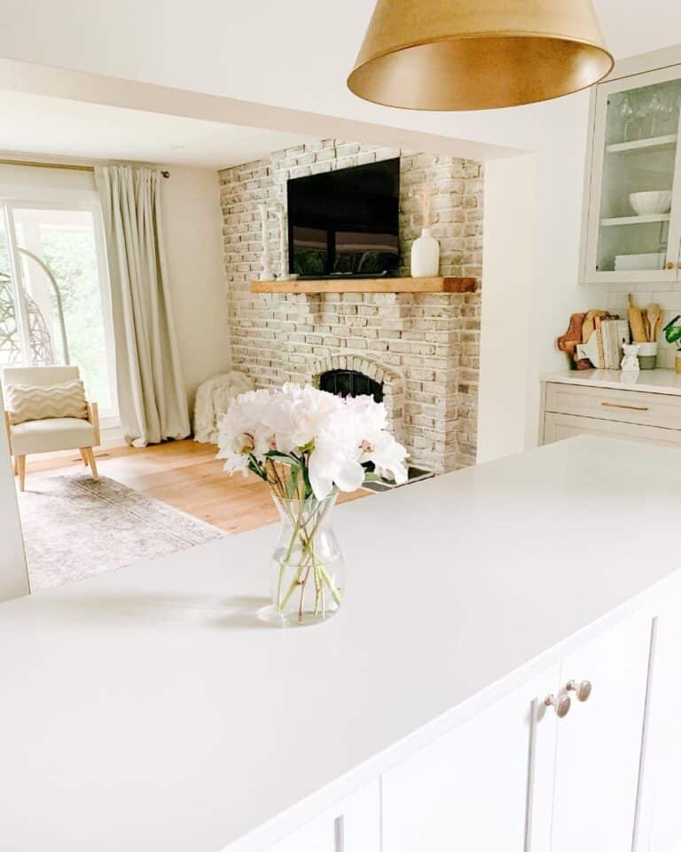 White Countertop and Cabinets with Brass Accents