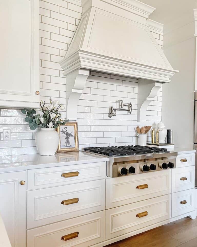 White Kitchen with Brass Cup Drawer Pulls