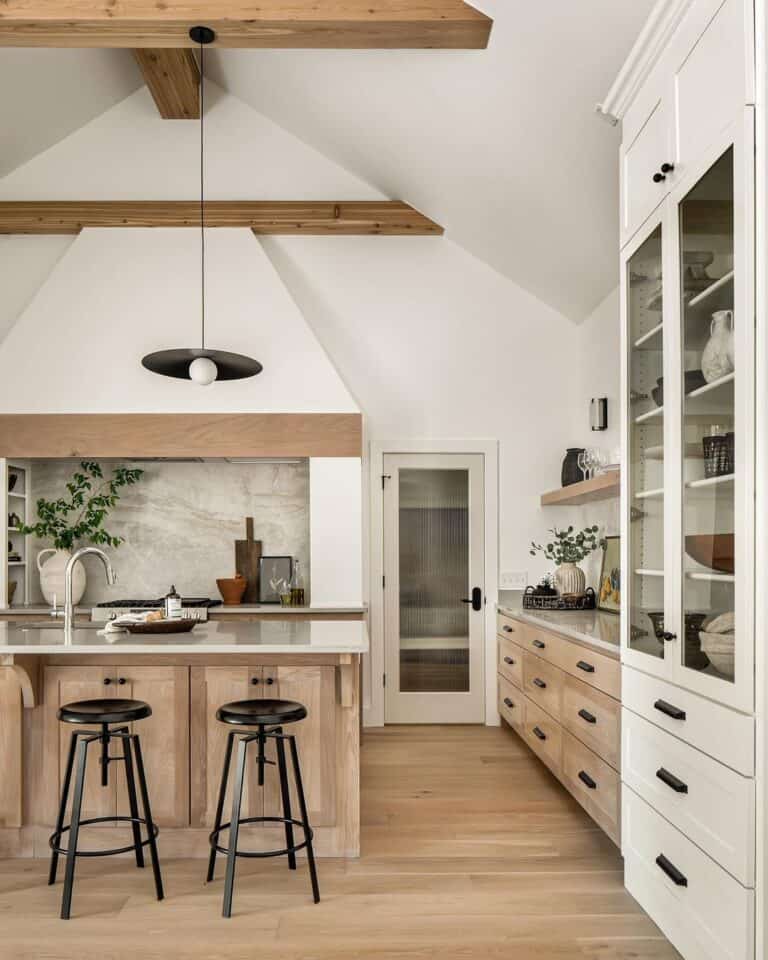 White and Wood Vaulted Ceiling Kitchen with Matte Black Cup Drawer Pulls