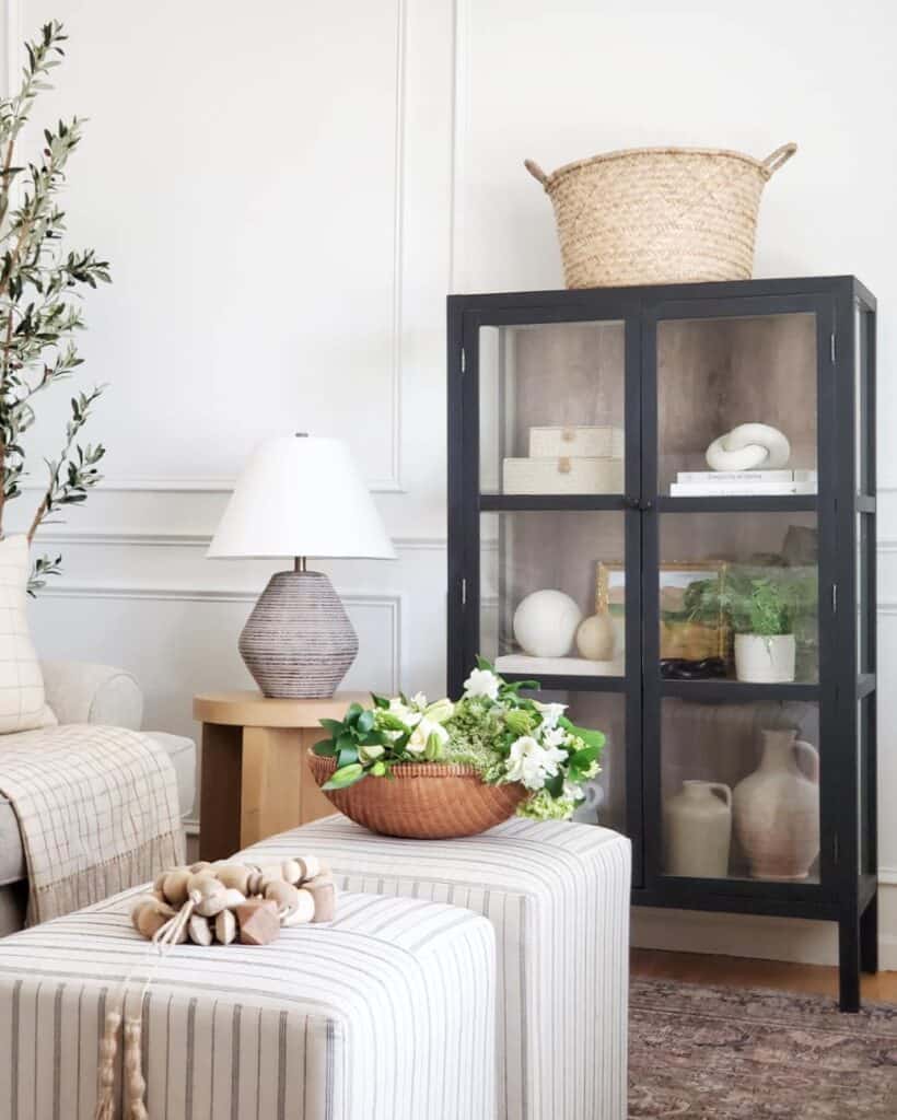 Wicker Basket on a Black China Cabinet With Glass Doors