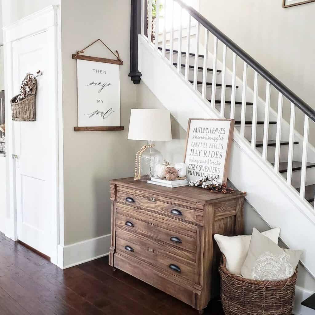 Wood Dresser Next to Black and White Staircase