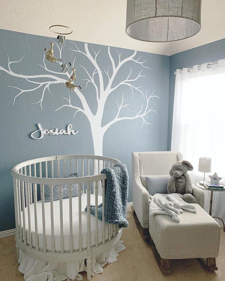 Baby Girl Nursery Themes Featuring a White Tree on a Blue Wall