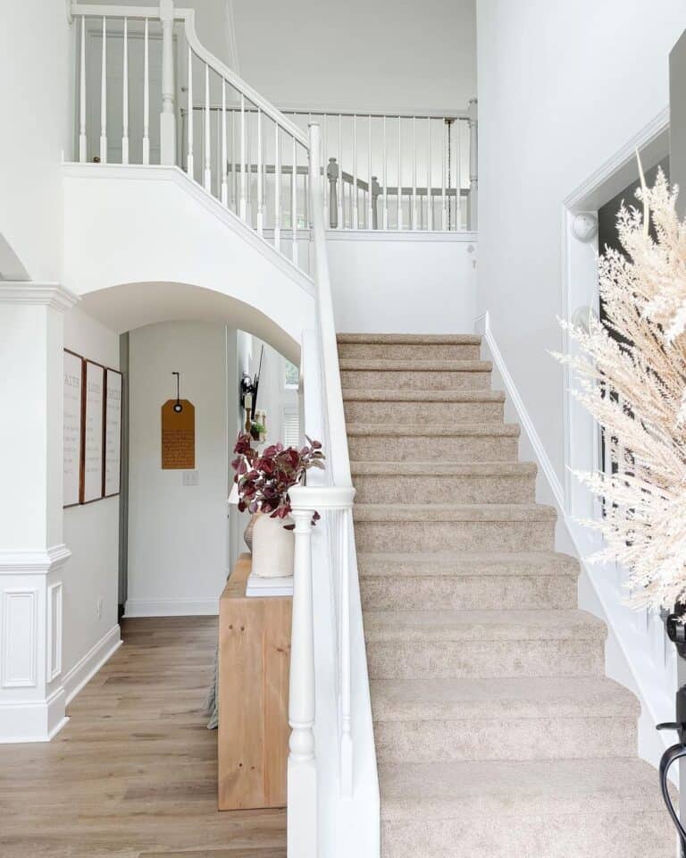Beige Carpeted Stairway with Stair Skirt Board