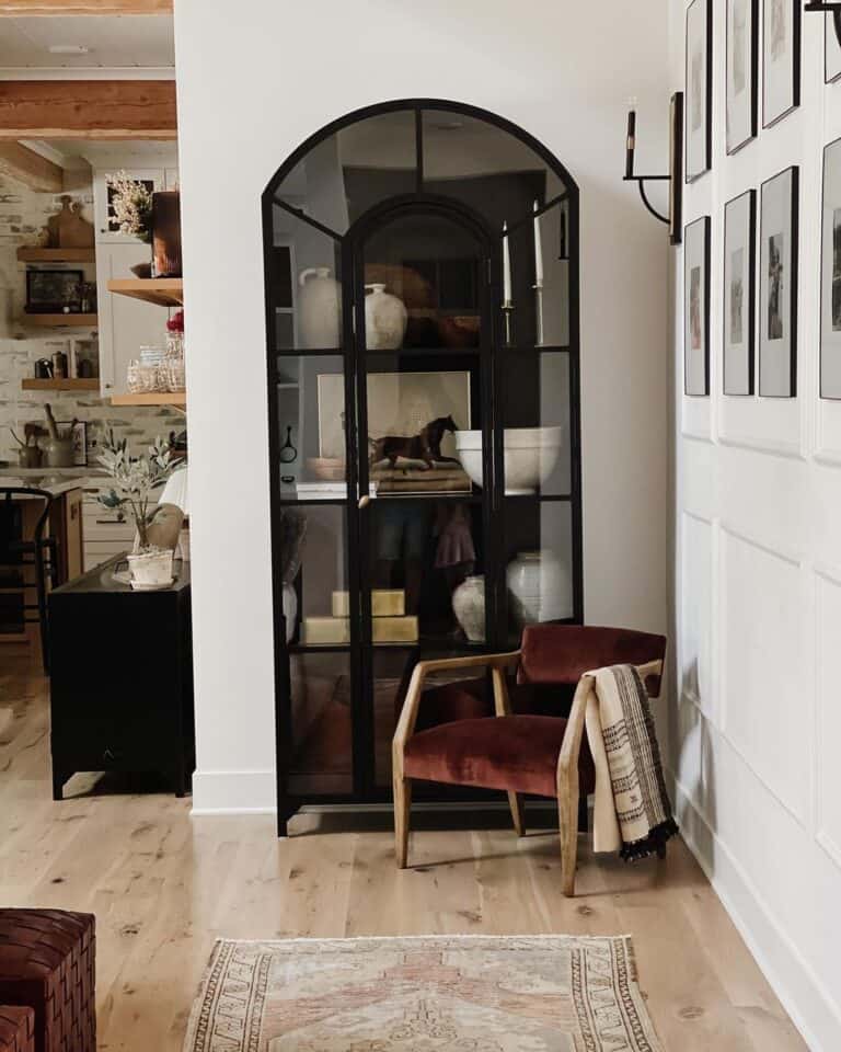 Black Arched Bookcase Cabinet Beside Gallery Wall