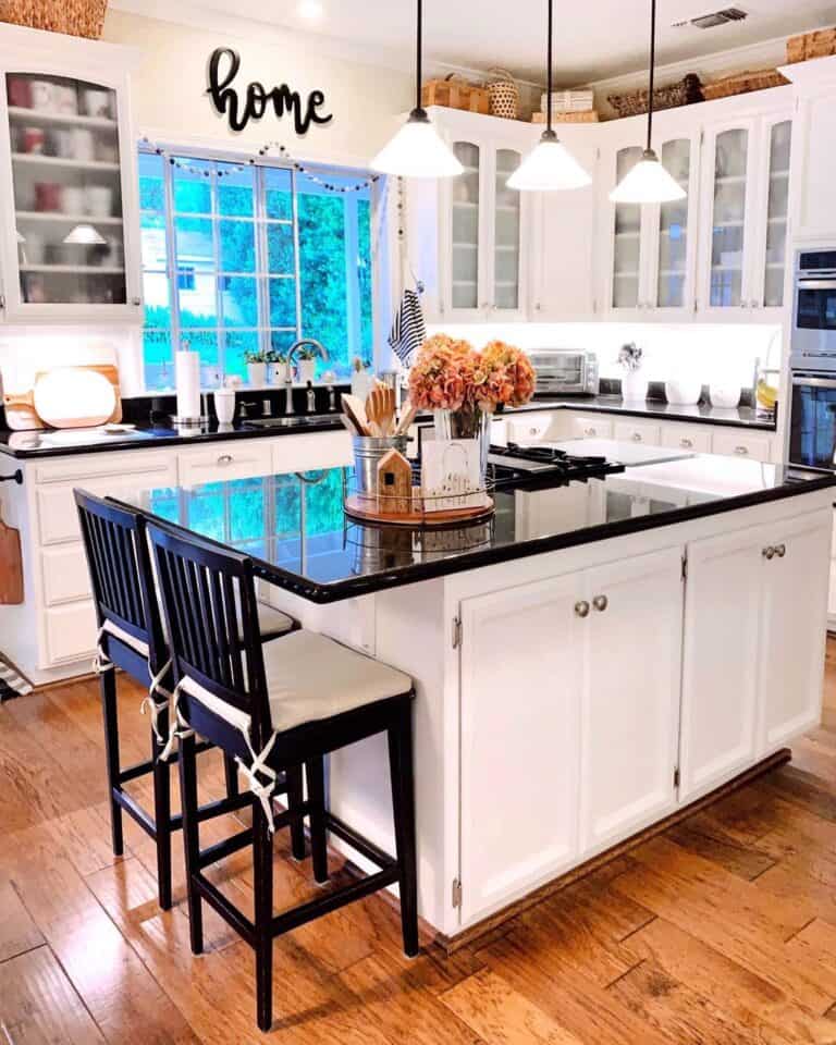 Black Bar Height Stools in a Black and White Kitchen