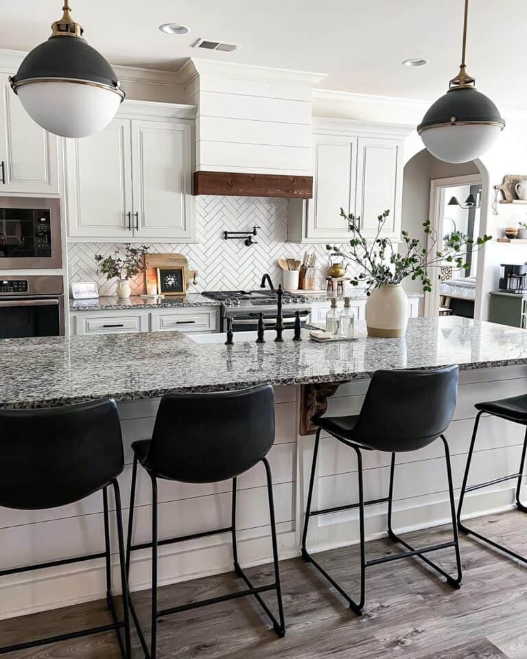 Black Bar Stools Under Black and White Pendant Lamps