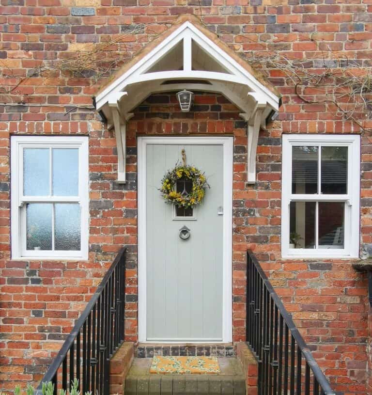 Black Railings Leading to Light Gray Door