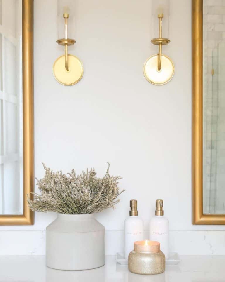 Brass Mirrors and Sconces in Neutral Bathroom