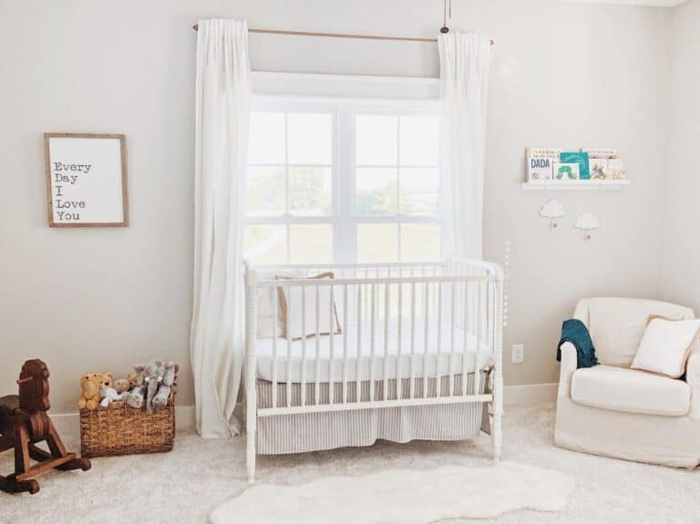 Crib Pushed Against a Window in a Baby Girl Nursery