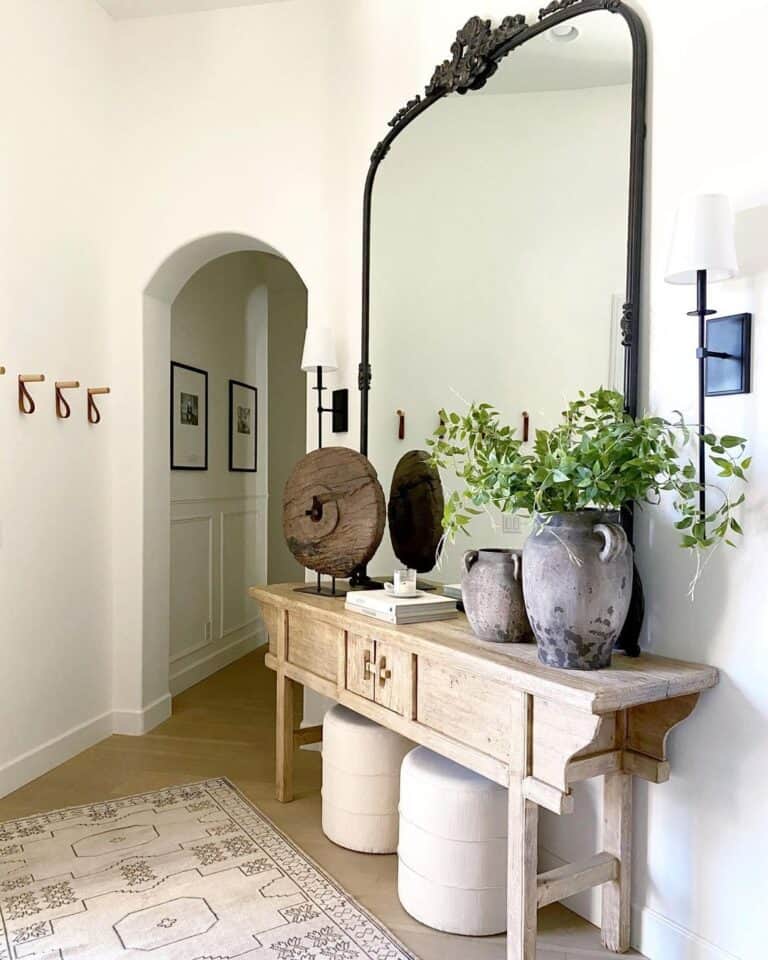 Entryway with Large Mirror and Small White Poufs