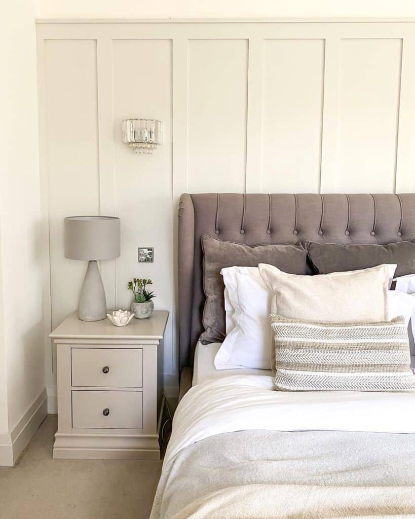 Gray Tufted Headboard Against Light Grey Wainscoting Soul & Lane
