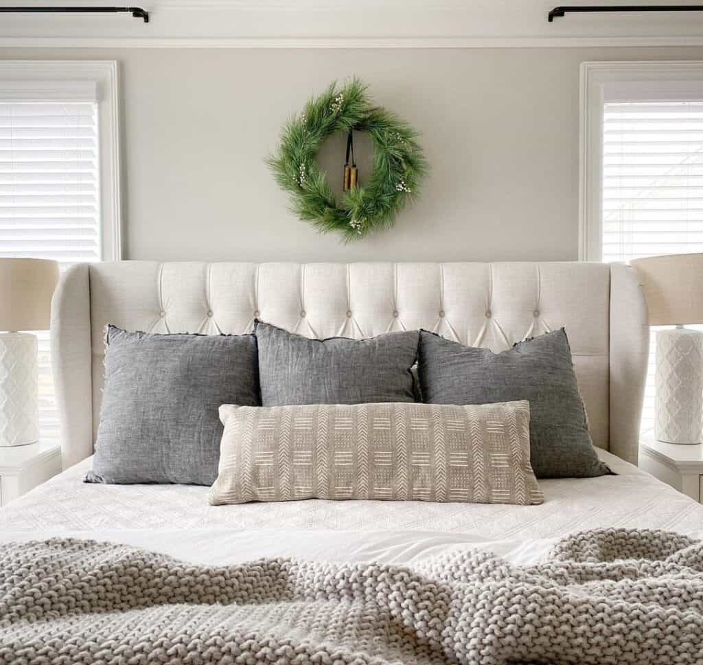 Green Wreath Above a Queen Tufted Headboard