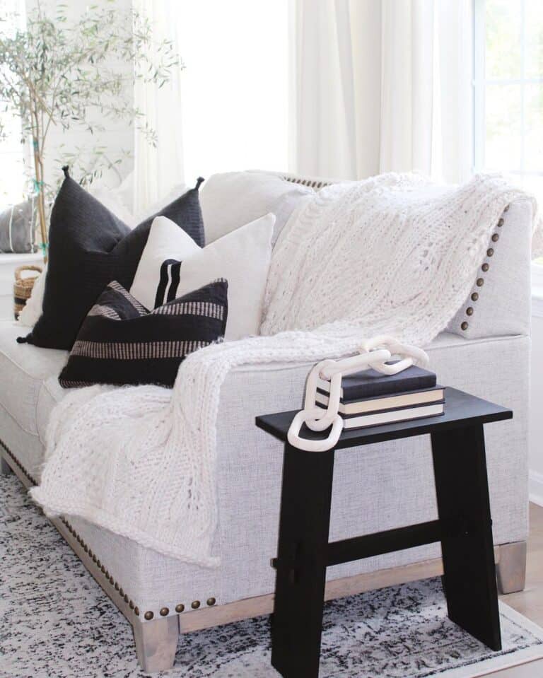 Knit Blanket Draped Over Studded Sofa