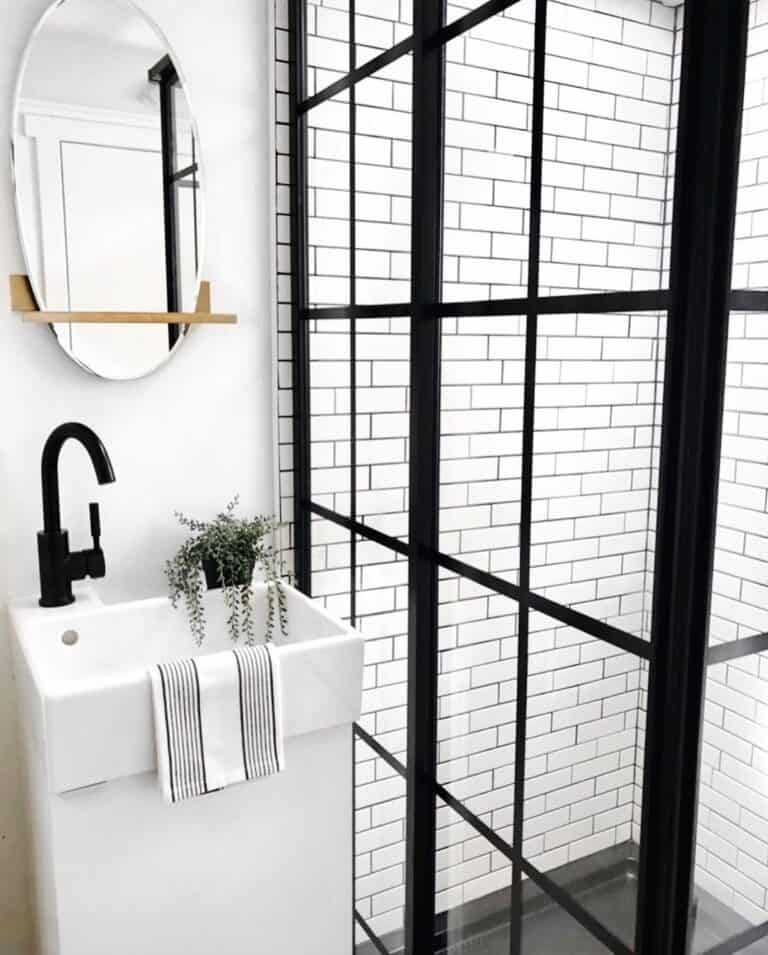 Modern Bathroom with White Subway Tile and Black Framed Shower Door
