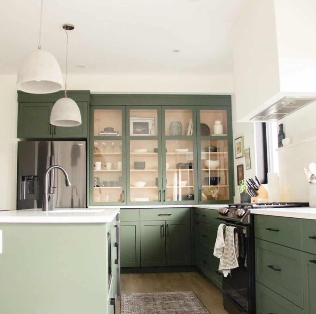 Modern Sage Green Kitchen Cabinets and a Black Stove
