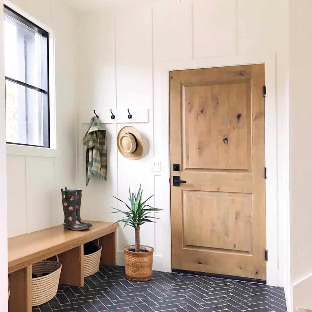Mudroom with Black Tile Floor and Wood Storage Bench