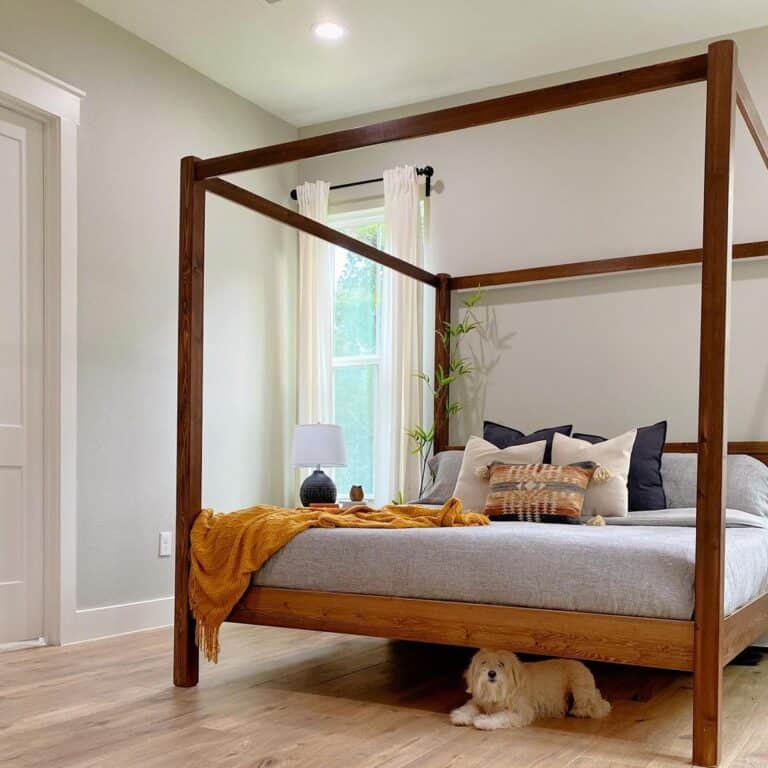 Orange Accents on Wood Canopy Bed