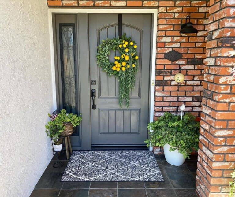 Paneled Gray Door on Brick Porch
