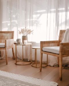 Round Gold Tables Between Cane Accent Chairs