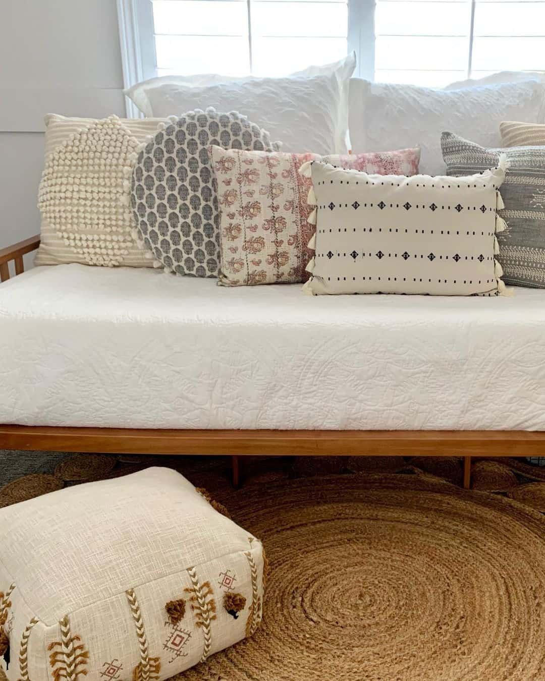 Variety of throw pillows on white futon couch soul lane