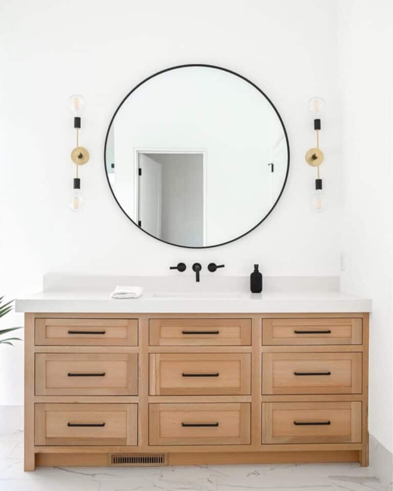 Wall Mounted Faucet Beneath Circular Mirror