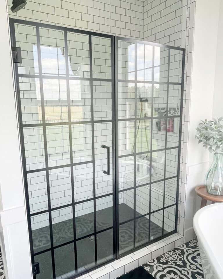 Well Lit Bathroom with Black Shower Door Soul & Lane