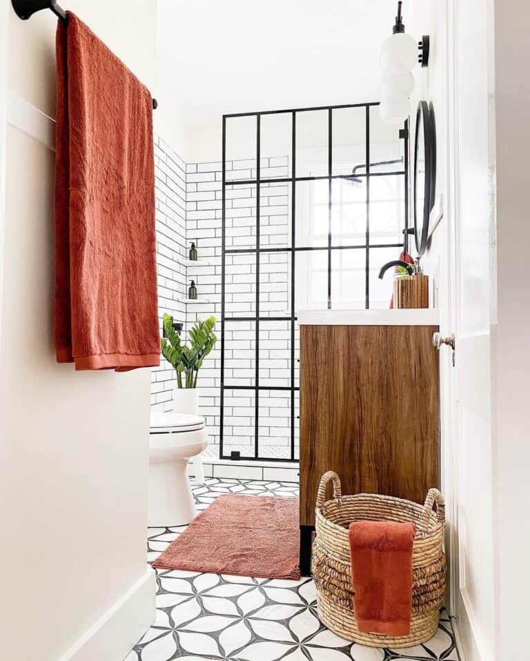 White Bathroom with Black Shower Door and Rust Red Accents