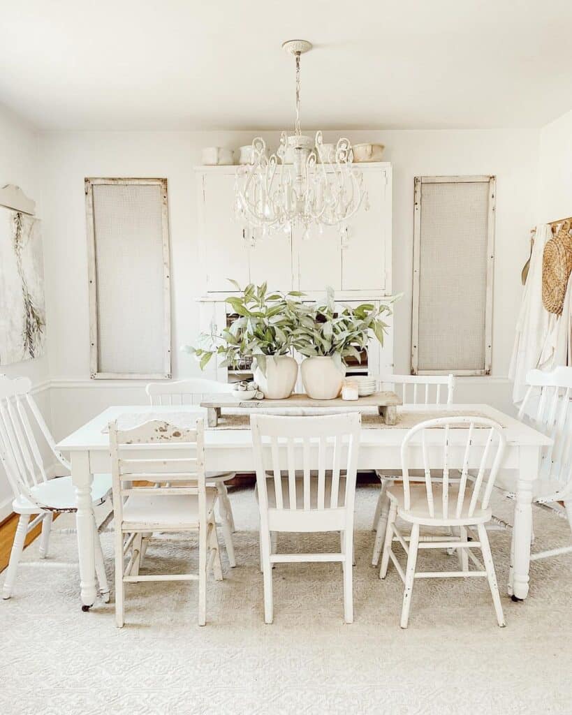 White Chandelier Over White Farmhouse Dining Table