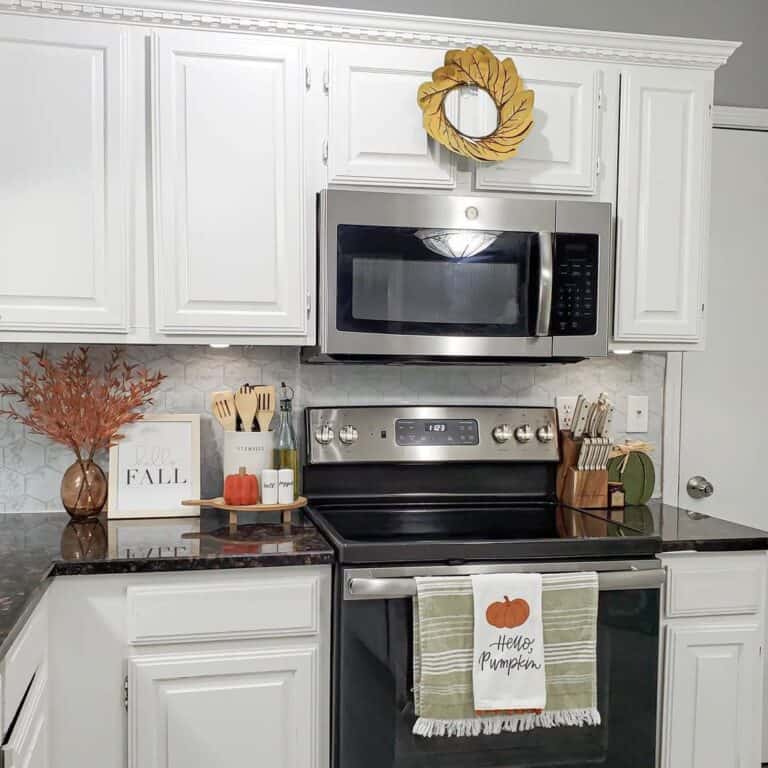 White Crown Molding for Kitchen Cabinets Above a Black Counter