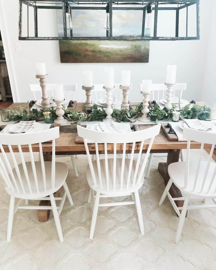 White Dining Room Chairs Under a Black Metal Chandelier