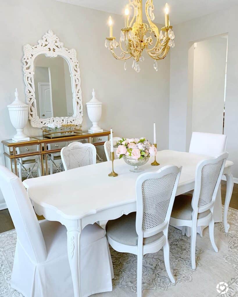 White Farmhouse Dining Table Under Gold Chandelier