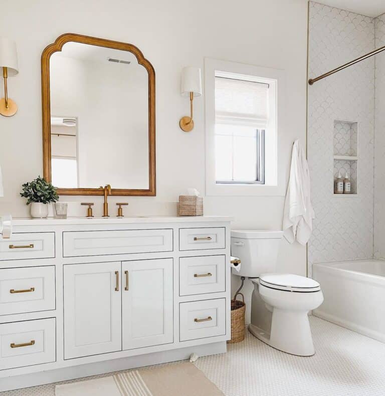 White Penny Tile Bathroom with Brass Sconces