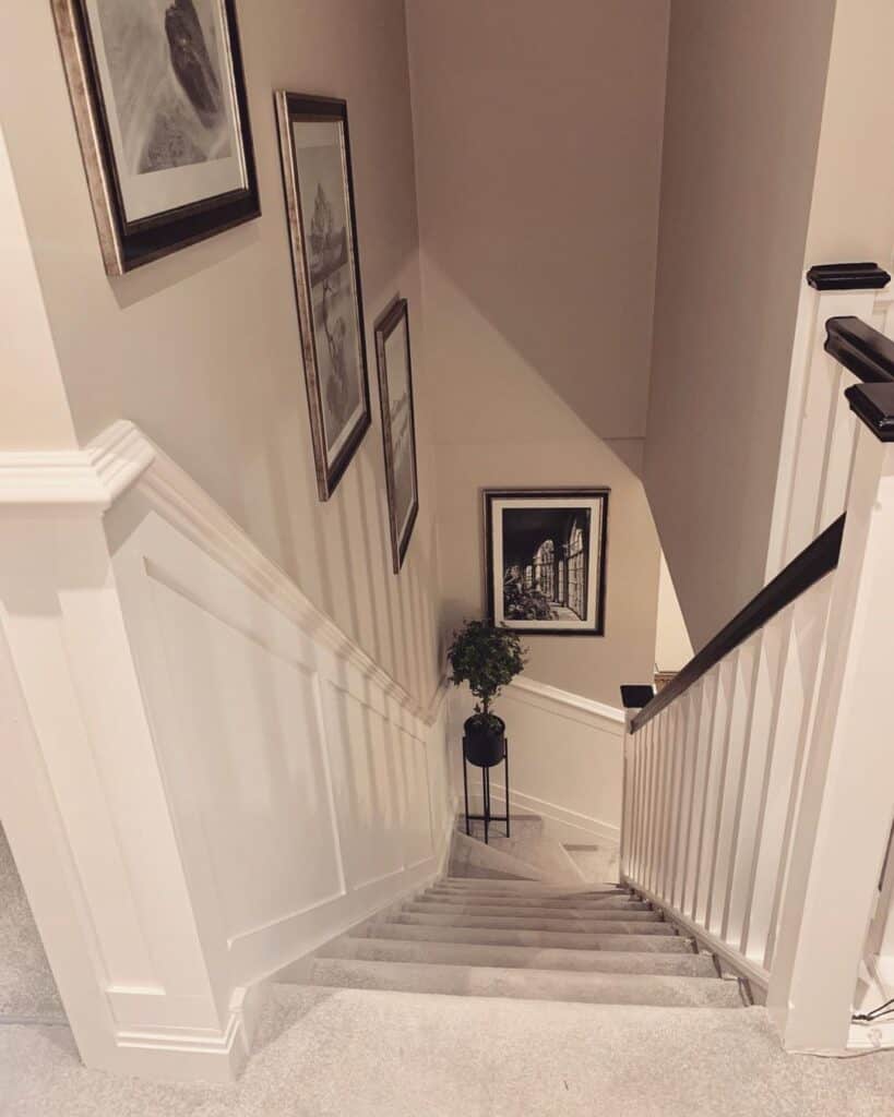 White Stairway Wainscoting with Gallery Wall