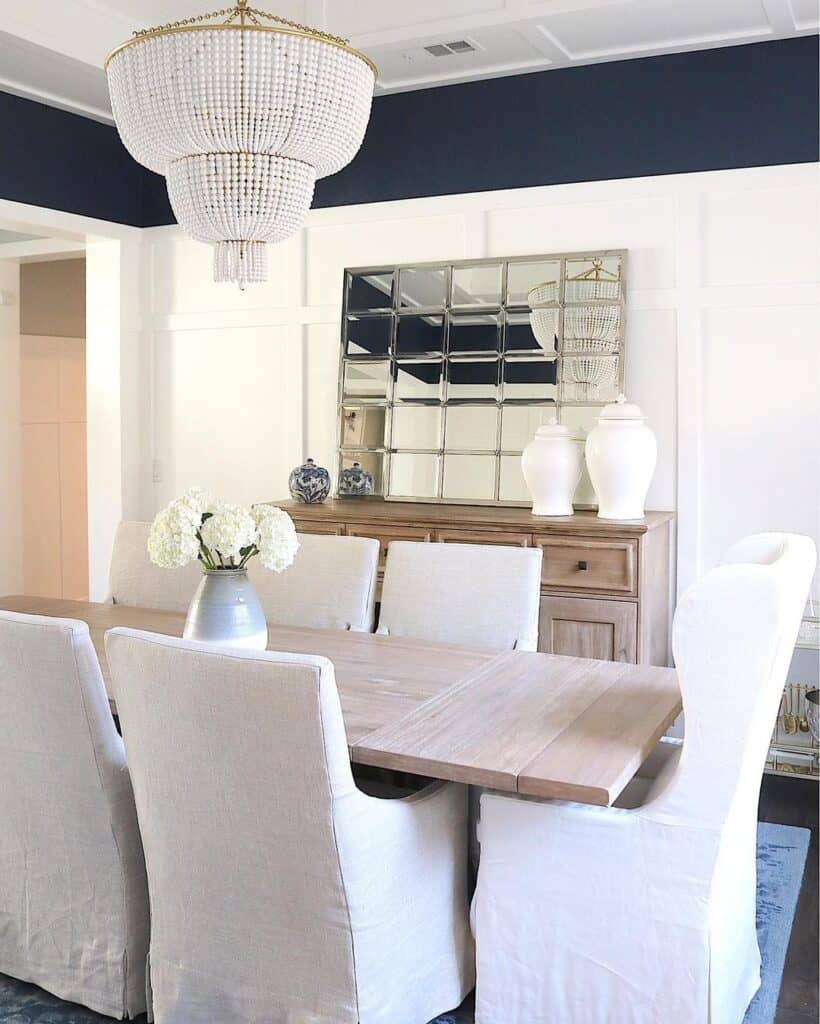 White Upholstered Dining Room Chairs Around a Light Wood Table