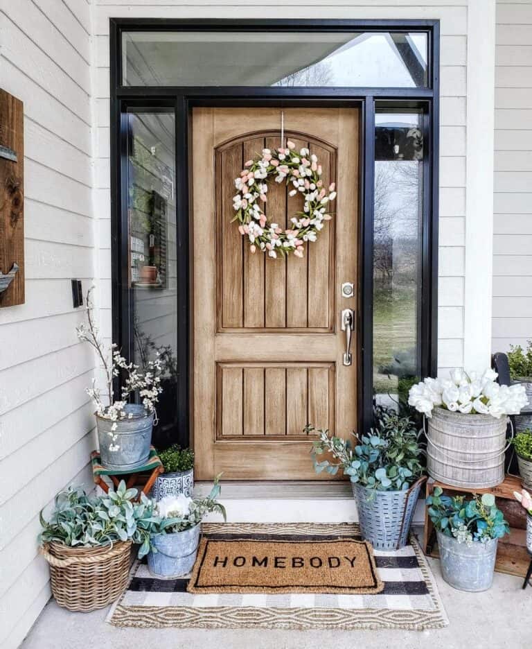 Wood Front Door with Floral Wreath and Potted Plants